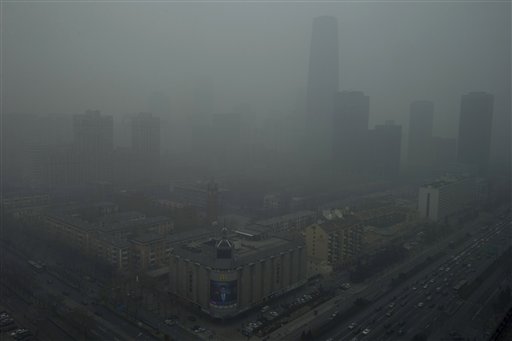 Skyscrapers are obscured by heavy haze in Beijing Sunday, Jan. 13, 2013. People refused to venture outdoors and buildings disappeared into Beijing's murky skyline on Sunday as the capital's air quality went off the index.  AP PHOTO/NG HAN GUAN