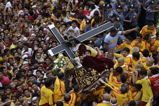 Catholic devotees jostle to get closer to the centuries-old image of the Black Nazarene in a raucous celebration on its feast day Wednesday, Jan. 9, 2013 in Manila, Philippines. The annual procession by hundreds of thousands of devotees is now becoming to be a tourist attraction. AP FILE PHOTO