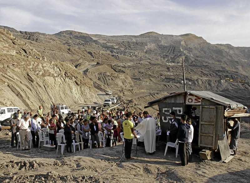 FAMILIES of the buried workers of Semirara Mining Corp., company officials and workers attend a Mass near the collapsed portion of the wall of the Pantian open mine pit. RAFFY LERMA
