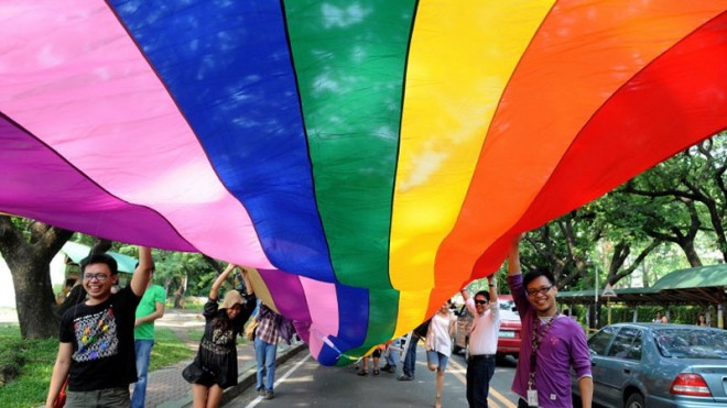 Filipino gays and lesbians march with placards on the University of the Philippines campus in Manila on June 28, 2011, as the world celebrate Lesbian, Gay, Bisexual and Transgender (LGBT) Pride. The LGBT group urged President Benigno Aquino to recognize and promote human rights for gays and lesbians. AFP FILE PHOTO