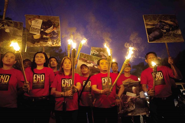Students and media groups participate in a torch parade in November 2014 condemning the slow pace of the trial of the 197 suspects in the Maguindanao massacre where 58 people, including 32 media workers, were killed. AFP