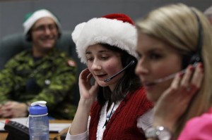 A volunteer takes phone calls from children asking where Santa is and when he will deliver presents to their house during the annual Norad Tracks Santa Operation in this Dec. 24, 2012, file photo. AP