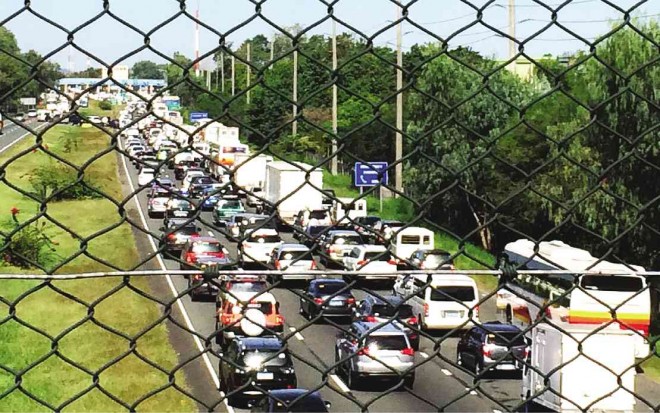 Traffic crawled to the Dau toll plaza along the North Luzon Expressway in Mabalacat City, Pampanga province, on Dec. 26, part of a long holiday weekend.  CONTRIBUTED PHOTO   