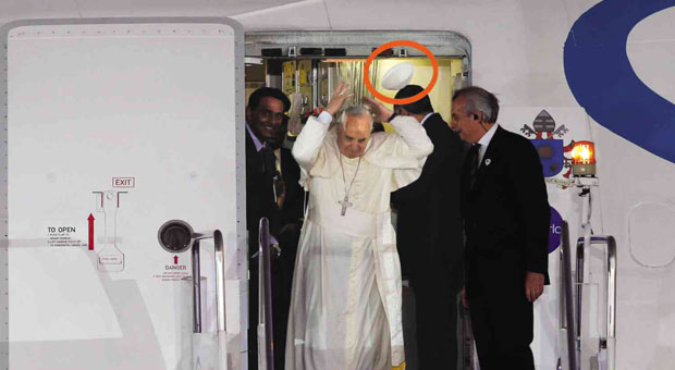SYMBOLIC  A gust of wind blows away the white cap off the head of Pope Francis as he prepares to descend the steps of the Sri Lankan plane that brought him to Manila from Colombo.  EDWIN BACASMAS