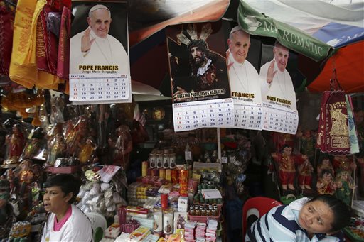Calendars with pictures of Pope Francis and an image of Jesus are sold in downtown Manila, Philippines on Monday, Jan. 5, 2015. AP