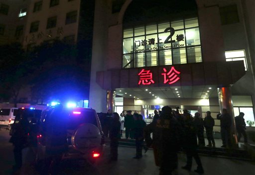 In this photo released by China's Xinhua News Agency, medical workers stand outside the emergency ward of the No. 1 People's Hospital of Shanghai after a stampede caused casualties among people who took part in New Year's celebrations in Shanghai, early on Thursday, Jan. 1, 2015.  AP PHOTO/XINHUA, DING TING  