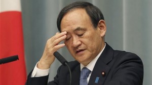 Japan's Government spokesman Chief Cabinet Secretary Yoshihide Suga ponders during a press conference at the prime minister's official residence in Tokyo Friday, Jan. 23, 2015 as militants affiliated with the Islamic State group have posted an online warning that the "countdown has begun" for the group to kill the pair of Japanese hostages. Suga reiterated Friday that Japan was trying all possible channels to reach those holding the hostages, and that its policy of providing humanitarian aid for those displaced by conflict in the Middle East was unchanged. (AP Photo/Koji Sasahara)