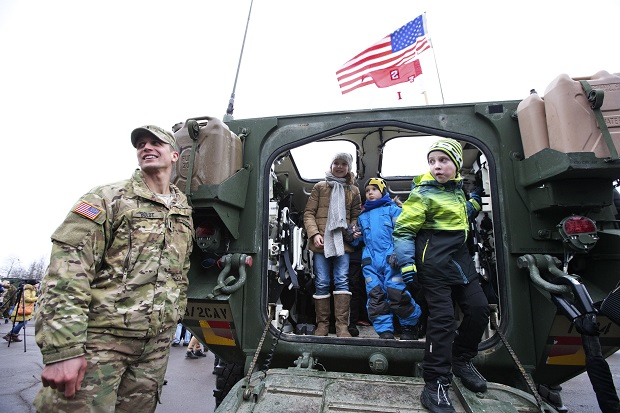 CAPTION CORRECTION, CORRECTS CITY AND DATE - U.S. soldiers from the NATO contingent participate in a parade in Narva, Estonia, Tuesday, Feb. 24, 2015. Troops and vehicles from U.S. and NATO regiments took part in the military parade to mark Estonias Independence Day near the Russian border, in the first known official appearance of the forces so close to the former Cold War enemy. (AP Photo/Liis Treimann)