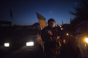 A Ukrainian serviceman guards a checkpoint in Severodonetsk, eastern Ukraine, Saturday, Feb. 21, 2015.Ukrainian military and separatist representatives exchanged dozens of prisoners under cover of darkness at a remote frontline location Saturday evening, kicking off a process intended to usher in peace to the conflict-ridden east. (AP Photo/Evgeniy Maloletka)