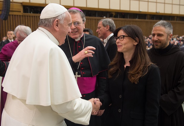 FILE -- In this file photo taken at the Vatican, on Feb. 4, 2015, Pope Francis shakes hands with Italian lawyer Lucia Annibali during the weekly general audience in the Pope Paul VI hall, . Annibali, became a symbol in the fight against men's violence toward women, after suffering in the 2013 an acid attack masterminded by her ex-boyfriend Luca Varani, also a lawyer. Varani has been convicted and sentenced to 20 years in prison for ordering the attack on his ex-girlfriend. Two Albanian men were convicted of throwing the acid and each received a 14 year term. On saturday in a speech, Francis decried disfiguring attacks on women. (AP Photo/L'Osservatore Romano, Pool)
