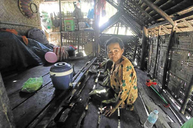 Bai Puti Kusain, 37, mother of 10, inside her hut in the village of Tukalanipao in Mamasapano town. She owns and tills the cornfield where 44 police commandos and a civilian were killed in the mission to get international terrorist Marwan. KARLOS MANLUPIG/INQUIRER MINDANAO