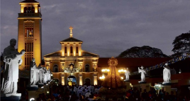 CLOSER TO HER Devotees of theOur Lady of the Rosary of Manaoag gather for the second of the three Masses or Triduum held Feb. 15, two days before the church was formally proclaimed aminor basilica by the Vatican. Built in the 17th century following aMarian apparition to a local farmer, the famous pilgrimage site in Pangasinan province, where many have attributed miraculous healings to the VirginMary, was granted the elevated status through anOct. 11, 2014 proclamation by Pope Francis. WILLIE LOMIBAO/INQUIRER NORTHERN LUZON