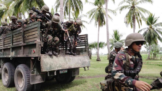 GOING AFTER BIFF  Army troops arrive in Pikit, North Cotabato province, on Feb. 25, 2015, after Gen. Gregorio Pio Catapang Jr., Armed Forces chief of staff, ordered an “all-out” operation against the Bangsamoro Islamic Freedom Fighters whose members have been attacking communities in the province since last week. Government forces have killed 73 Moro rebels, including one described as “foreign-looking” who may be among terror suspects sought by the United States, the military said on Monday, March 10. JEOFFREY MAITEM/INQUIRER MINDANAO