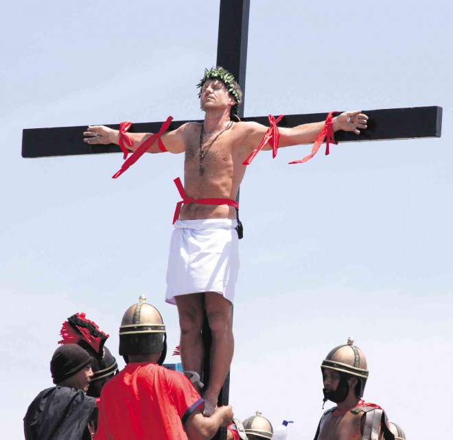 NO ROLE PLAYING  Danish filmmaker Lasse Spang Olsen steals the limelight after being nailed to the cross in Barangay San Pedro Cutud in San Fernando, Pampanga province, on Good Friday in 2014. Olsen, 49, could be the last foreign national to take part in the reenactment of the crucifixion of Christ after local officials banned foreigners from participating in the annual Holy Week rites. E.I. REYMOND T. OREJAS/ CONTRIBUTOR