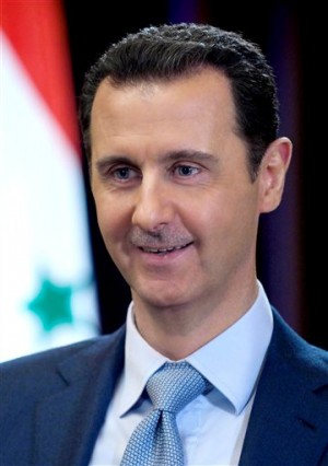In this photo released on Tuesday, Feb. 10, 2015, by the Syrian official news agency SANA, Syrian President Bashar Assad smiles during an interview with the BBC, in Damascus, Syria. AP