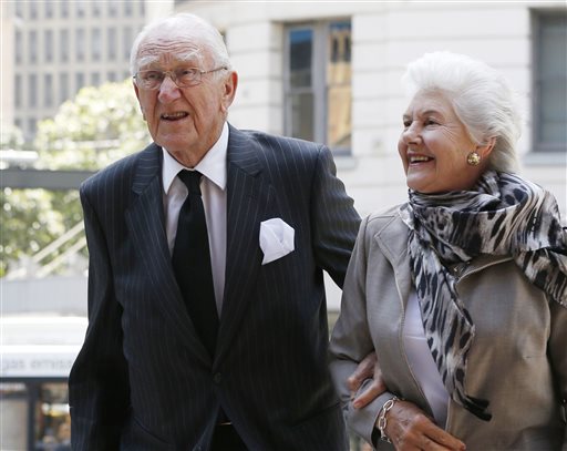 FILE - In this Nov. 4, 2014 file photo, former Australian Prime Minister Malcolm Fraser, left, arrives at Town Hall with his wife Tamie for a memorial service for former Australian Prime Minister Gough Whitlam in Sydney. Malcolm Fraser, the former Australian prime minister who was notoriously catapulted to power by a constitutional crisis that left the nation bitterly divided, died on Friday, March 20, 2015 his office said. He was 84. (AP Photo/Jason Reed, File)