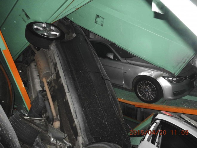 In a photo provided by the Taipei Fire Department, vehicles are seen piled on themselves in an automated parking tower after the lift system failed during the 6.3 magnitude earthquake that struck off the island's eastern coast in Taipei, Taiwan, Monday, April 20, 2015. No injuries resulted in the accident. The date that this photo was taken, seen in bottom right, is from the camera of the Taipei Fire Department. (Taipei Fire Department via AP)