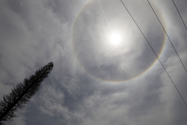 A solar halo appears during the beatification ceremony for Roman Catholic Archbishop Oscar Romero in San Salvador, El Salvador, Saturday, May 23, 2015. The solar halo is an optical phenomenon produced when sunlight refracts through ice crystals in the atmosphere. (AP Photo/Moises Castillo)