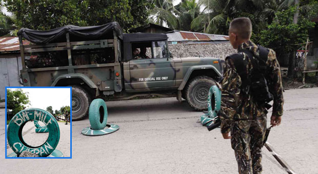 ALL QUIET ON THE SOUTHERN FRONT While the proposed Bangsamoro Basic Law faces delays and legal challenge in Congress and in the Supreme Court, combatants from both sides enjoy relative peace as a military transport passes a checkpoint set up by the Moro Islamic Liberation Front (MILF) in Sultan Kudarat, Maguindanao province.  The MILF checkpoint is marked by an old tire (inset). JEOFFREY MAITEM / INQUIRER MINDANAO