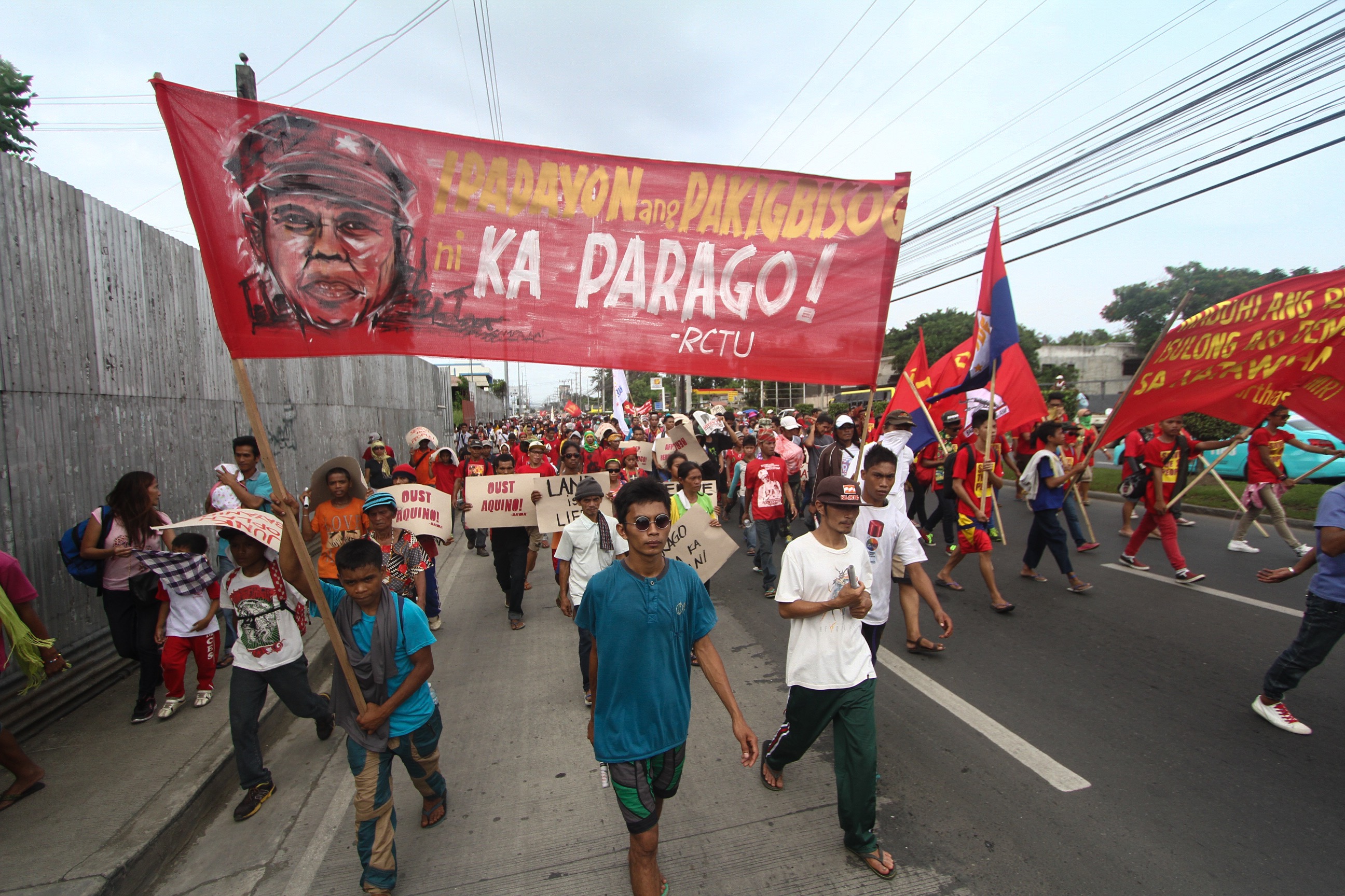  With guards standing in full attention, the body of slain New People's Army commander Leoncio "Parago" Pitao, which was enclosed in a plain white coffin adorned by the red hammer and sickle flag, was paraded around Davao City accompanied by at least 10,000 supporters.  PHOTO BY KARLOS MANLUPIG/INQUIRER MINDANAO