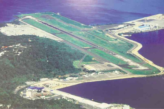A WALL poster at the Subic Bay International Airport, formerly known as US Air Station, shows an aerial view of the site where combat planes of the Philippine Air Force will be stationed as the country readies a section of this free port in Zambales as a military base. PHOTO REPRODUCTION BY ALLAN MACATUNO 