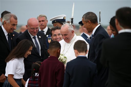 Pope Francis, accompanied by President Barack Obama and others, is greeted upon his arrival at Andrews Air Force Base, Maryland, Tuesday, Sept. 22, 2015.  AP PHOTO/ANDREW HARNIK 