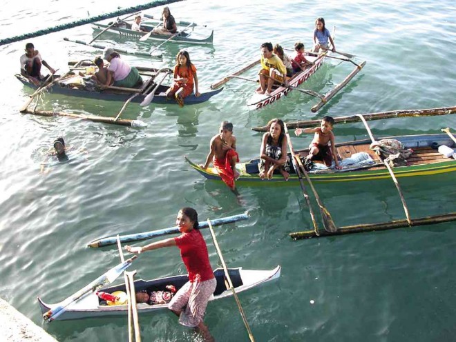 SOME members of the sea tribe have found their way off the Talao-Talao pier in Lucena City, Quezon province, begging for coins from passengers of Marinduque-bound ships.      DELFIN T. MALLARI JR./INQUIRER SOUTHERN LUZON