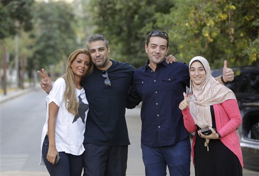 Canadian Al-Jazeera English journalist Mohamed Fahmy second left, and his Egyptian colleague Baher Mohammed, celebrate with their wives after  being released from Torah prison in Cairo, Egypt, Wednesday, Sept. 23, 2015. Fahmy and his colleague Baher, were among a group of 100 people pardoned by Egyptian President Abdel-Fattah el-Sissi on the eve of the major Muslim holiday of Eid al-Adha. The pardon also comes a day before the Egyptian leader is to travel to New York to attend the United Nations General Assembly. AP PHOTO