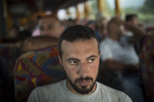Mohammed al-Haj, a 26-year-old from Aleppo, was one of more than 600,000 migrants and refugees who flowed into Europe so far this year. Nearly half of those were Syrians, like Mohammed, fleeing their countrys brutal civil war. The Associated Press followed Mohammed on nearly every step of his 2,500-mile journey in September, starting from Killis, Turkey, where his family lived for a year after escaping Syria. Mohammed said that for him, Syria is finished. It will only get worse and finally break apart. Europe means a life of dignity, where at least ... I will feel I have rights. He is pictured here on Thursday, Sept. 10, 2015 on a bus in Greece during his journey. (AP Photo/Santi Palacios)