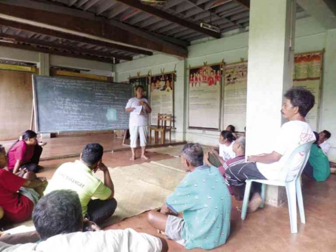 LINTAWAGIN presides over a Mangyan community meeting to thresh out problems.