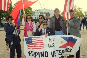 Jon Melegrito (left) of the Filipino Veterans Recognition and Education Project speaks in support of 98-year-old veteran Celestino Almeda (center) in front of the White House on Veterans Day. (Photo by Eric Lachica/ACFV)