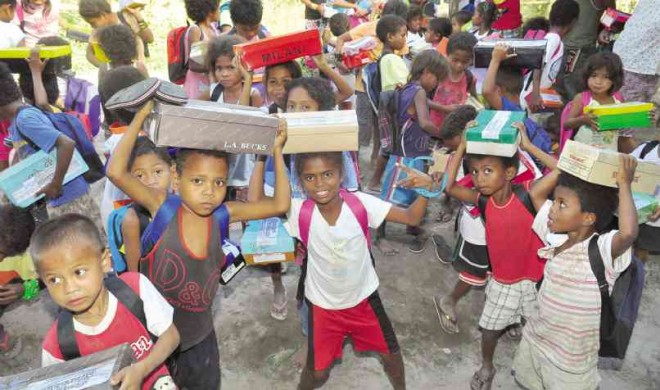CHILDREN of indigenous people in the Sierra Madre in northern Quezon province receive shoeboxes filled with emergency kits. DELFIN T. MALLARI JR.