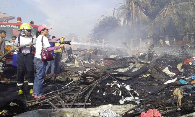 Volunteers help fight the Oct. 31 fire that killed 15 people in Zamboanga City. CONTRIBUTED PHOTO