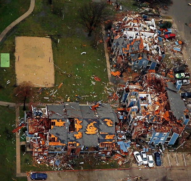 Damage to an apartment complex is seen after Saturday's tornado in Garland, Texas, Sunday, Dec. 27, 2015. At least 11 people died and dozens were injured in apparently strong tornadoes that swept through the Dallas area and caused substantial damage this weekend. (G.J. McCarthy/The Dallas Morning News via AP) MANDATORY CREDIT