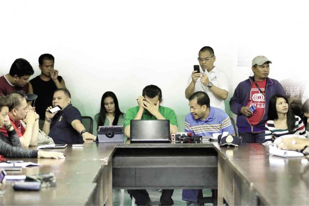 ALBAY Gov. Joey Salceda (center, hand partly covering his face) presides over a meeting of disaster agencies in the province in preparation for the onslaught of Typhoon “Nona” (international name: Melor) on Dec. 14.  MARK ALVIC ESPLANA/INQUIRER SOUTHERN LUZON
