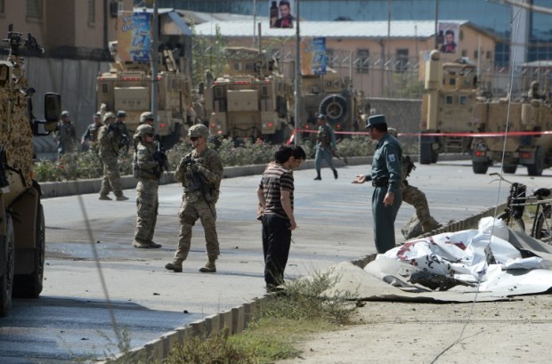 NATO soldiers and Afghan security forces arrive at the scene of suicide car bomb attack that targeted foreign military vehicles at Jo-e-Sher in Kabul on October 11, 2015. FILE PHOTO 