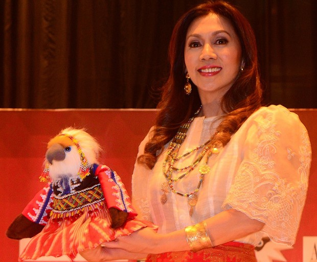 DESIGNER TOY In a Renee Salud outfit, a Philippine eagle stuffed toy is presented for auction by Jackie Garcia-Dizon, immediate past president of Hijos de Davao, to raise funds for the protection of the critically endangered bird species. JINGGOY SALVADOR/CONTRIBUTOR
