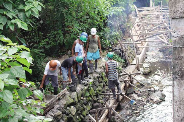 Villagers in three coastal villages of Sto. Domingo town in Albay province volunteer to do labor work in building a dike to keep their communities safe from floods. The project is under the Kalahi-CIDSS program of the Department of Social Welfare and Development. CONTRIBUTED PHOTO