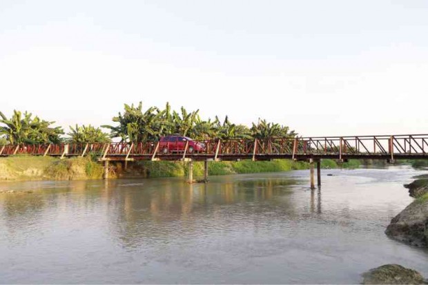 MOTORISTS cross a new steel bridge that took the place of one in Tukanalipao village, Mamasapano town, that became infamous for being the site where many of the SAF 44 commandos were killed.