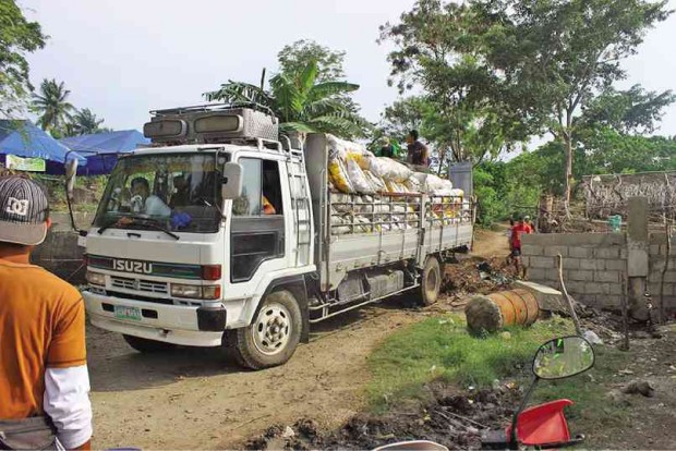 A TRUCK is loaded with copra harvested by farmers in Hacienda Matias in Quezon province. The estate, mainly planted to coconuts, has been placed under agrarian reform.    DELFIN T. MALLARI JR.