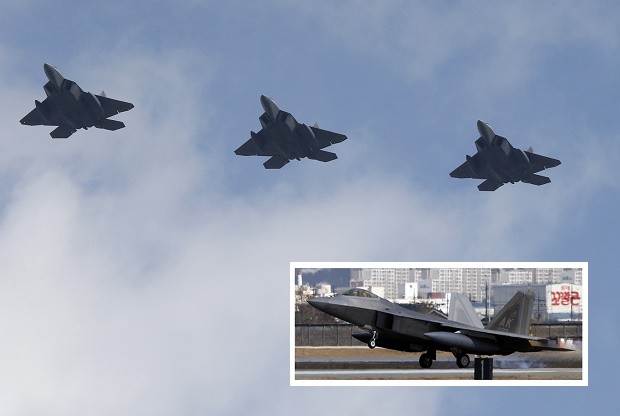 Four U.S. F-22 stealth fighters fly over Osan Air Base in Pyeongtaek, South Korea, Wednesday, Feb. 17, 2016. Four U.S. F-22 stealth fighters flew over South Korea on Wednesday in a clear show of power against North Korea, a day after South Korea's president warned of the North's collapse amid a festering standoff over its nuclear and missile ambitions. (AP Photo/Lee Jin-man)