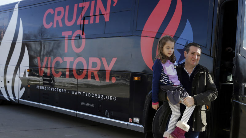 Republican presidential candidate, Sen. Ted Cruz, R-Texas, carries his daughter Caroline, 7, as he arrives at Green County Community Center for a campaign event, Monday, Feb. 1, 2016, in Jefferson, Iowa. (AP Photo/Chris Carlson)