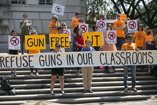 FILE - In this Oct. 1, 2015, file photo, protesters gather on the West Mall of the University of Texas campus to oppose a new state law that expands the rights of concealed handgun license holders to carry their weapons on public college campuses. University of Texas President Greg Fenves has approved rules that will allow concealed handgun license holders to bring their weapons into classrooms. State law requires public universities to allow concealed handguns in classrooms and buildings starting Aug. 1, 2016, but also gives campuses some leeway to carve out gun-free zones. (Ralph Barrera/Austin American-Statesman via AP, File) AUSTIN CHRONICLE OUT, COMMUNITY IMPACT OUT, INTERNET AND TV MUST CREDIT PHOTOGRAPHER AND STATESMAN.COM, MAGS OUT; MANDATORY CREDIT
