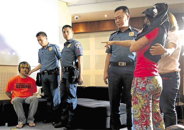 ‘That’s him’   A rape and robbery complainant points to Nitro Agustin Ison as her alleged attacker, during a press conference that presented the suspect in Camp Crame on Friday. The police are linking the 24-year-old to a spate of crimes in Makati, Mandaluyong, Taguig, Pasay and Quezon City.       RICHARD A. REYES