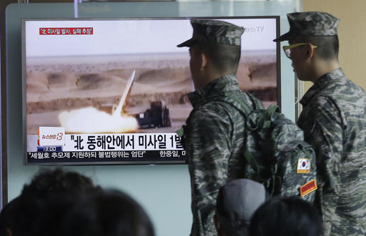 South Korean army soldiers pass by a TV news program showing a file footage of a missile launch conducted by North Korea at Seoul Railway Station in Seoul, South Korea, Friday, April 15, 2016. AP 