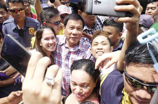 SELFIE SENSATION    Davao City Mayor Rodrigo Duterte obliges supporters with a selfie during a campaign sortie in Rizal province in March. Under a new protocol, such close contact with the presumptive President-elect is no longer possible. GRIG C. MONTEGRANDE 