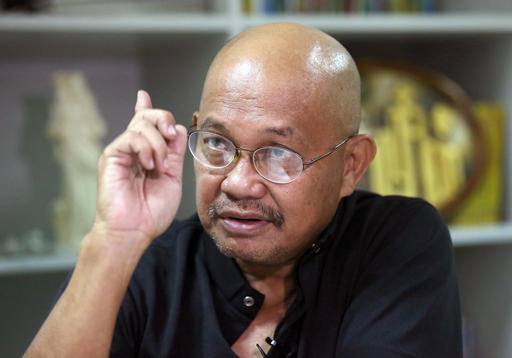 In this May 13, 2016 photo, Filipino Catholic priest Father Amado Picardal gestures during an interview at the Catholic Bishops' Conference of the Philippines office in Manila, Philippines. Nine years ago Picardal helped bury a teenager from a slum family who was gunned down by motorcycle-riding assassins in the southern Philippine city of Davao. (AP Photo/Aaron Favila)