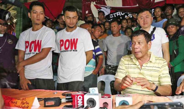 RELEASED Pfc. Diven Tawide and Pfc. Glenn Austria, who were held captives by the New People’s Army for a month, are turned over to Davao City Mayor Rodrigo Duterte and other local officials in a remote village in San Luis, Agusan del Sur province. BARRY OHAYLAN / CONTRIBUTOR