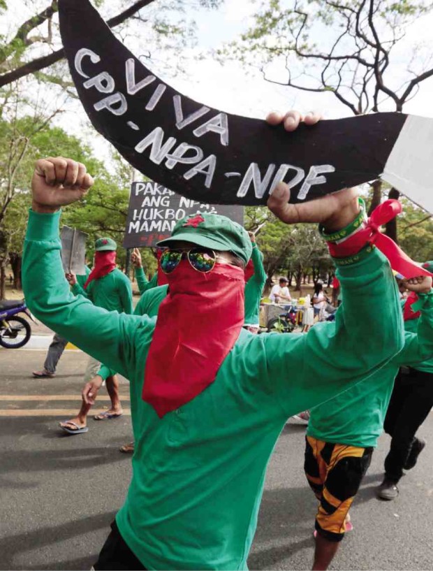 UNDERGROUND leftist cadres march in Quezon City on March 29 to celebrate the 47th founding anniversary of the New People’s Army, which has gone on an offensive in the last remaining weeks in office of President Aquino.    GRIG C. MONTEGRANDE