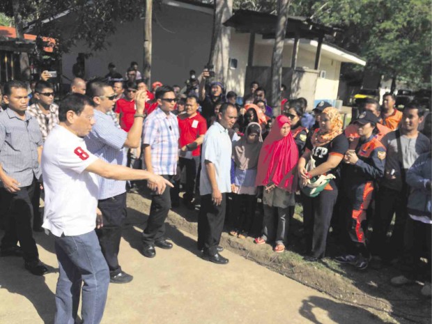 BREAKING PROTOCOL IN BASILAN       Breaking protocol, President Duterte moves near Basileños gathered at Camp Luis Biel II in Barangay Tabiawan, Isabela City, Basilan province, on Thursday. JULIE ALIPALA/INQUIRER MINDANAO